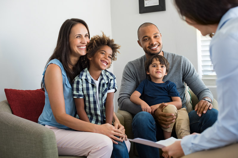 Family sitting together with realtor